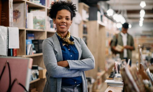 Confident woman business owner with her arms crossed thinks about her entrepreneurial mindset