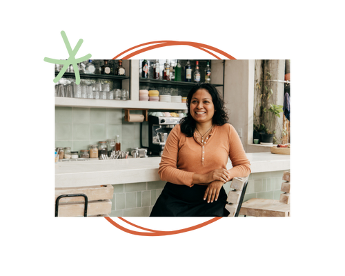 A woman business owner stands in her store